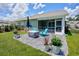 Expansive backyard features stone patio with seating, screened porch, manicured lawn, and fenced perimeter at 204 Kinross Ct., Little River, SC 29566
