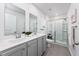 Bathroom featuring double sinks, a glass shower, and modern fixtures at 204 Kinross Ct., Little River, SC 29566