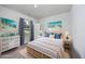 Staged bedroom featuring a light wood bed frame, bright colors, and two bedside tables at 204 Kinross Ct., Little River, SC 29566