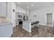 Modern kitchen with an island, granite countertops, stainless steel appliances, and stylish pendant lighting at 204 Kinross Ct., Little River, SC 29566