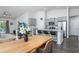 Open-concept kitchen and dining area featuring stainless steel appliances and island seating at 204 Kinross Ct., Little River, SC 29566
