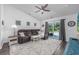 Cozy living room features a plush sofa, ceiling fan, sliding glass doors to the backyard patio, and a TV at 204 Kinross Ct., Little River, SC 29566