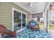 Cozy screened porch with comfortable seating and stylish decor, creating a relaxing outdoor space at 204 Kinross Ct., Little River, SC 29566