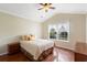 Well-lit bedroom with hardwood floors, complemented by a beige comforter set and a bedside table at 2210 Haystack Way, Myrtle Beach, SC 29579