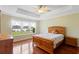 Tranquil bedroom featuring a wooden bed frame, light yellow walls, and scenic views of the lake at 2210 Haystack Way, Myrtle Beach, SC 29579