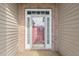 Close-up of the front door with sidelights and a decorative glass panel, framed by brick and siding at 2210 Haystack Way, Myrtle Beach, SC 29579