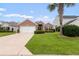Beautiful home with brick and manicured lawn. Garage and palm tree add to the curb appeal at 2210 Haystack Way, Myrtle Beach, SC 29579