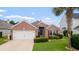 Charming brick home with a well-manicured lawn and an attached two-car garage at 2210 Haystack Way, Myrtle Beach, SC 29579