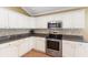 Beautiful kitchen featuring white cabinets, granite counters, stainless steel appliances, and a mosaic tile backsplash at 2210 Haystack Way, Myrtle Beach, SC 29579