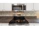 Up close detail of a well maintained kitchen, featuring stainless steel appliances and granite countertops at 2210 Haystack Way, Myrtle Beach, SC 29579