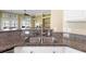 Kitchen sink features granite counters, a stainless steel faucet, and views of the backyard and fireplace at 2210 Haystack Way, Myrtle Beach, SC 29579