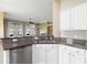 Modern kitchen showcasing granite countertops, a stainless steel dishwasher, and a breakfast bar overlooking the backyard at 2210 Haystack Way, Myrtle Beach, SC 29579