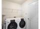 Functional laundry room with a modern washer and dryer, complete with shelving for storage at 2210 Haystack Way, Myrtle Beach, SC 29579