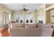 Bright and airy living room featuring a fireplace, hardwood floors, and a ceiling fan with access to the backyard at 2210 Haystack Way, Myrtle Beach, SC 29579