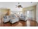 Bright living room featuring hardwood floors, a ceiling fan, and a view into the adjoining kitchen at 2210 Haystack Way, Myrtle Beach, SC 29579