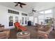 Inviting sunroom with wicker furniture, ceiling fans, and surrounded by windows bringing in natural light at 2210 Haystack Way, Myrtle Beach, SC 29579