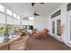Relaxing sunroom featuring wicker furniture, ceiling fans, and an abundance of natural light streaming through numerous windows at 2210 Haystack Way, Myrtle Beach, SC 29579