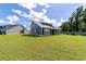 A spacious, well-manicured backyard featuring a screened-in porch and lush green grass at 2212 Leeboard Ct., Myrtle Beach, SC 29579