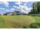 A spacious, well-manicured backyard with a screened-in porch and lush green grass at 2212 Leeboard Ct., Myrtle Beach, SC 29579