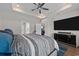This spacious bedroom features a tray ceiling, ceiling fan, TV, and hardwood flooring at 2212 Leeboard Ct., Myrtle Beach, SC 29579
