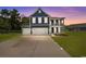 Charming home with a three-car garage, covered porch, and well-manicured lawn at 2212 Leeboard Ct., Myrtle Beach, SC 29579