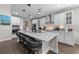 Modern kitchen boasts a large island with seating, stainless appliances, and white cabinetry at 2212 Leeboard Ct., Myrtle Beach, SC 29579