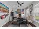 Home office area features a ceiling fan, a large desk, neutral paint, dark flooring and bright, natural light at 2212 Leeboard Ct., Myrtle Beach, SC 29579