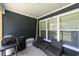 Cozy screened-in porch featuring a seating area, lovely siding, and access to the backyard at 2212 Leeboard Ct., Myrtle Beach, SC 29579