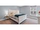 Well-lit bedroom with carpeted floors, a window, and a white bed with cozy bedding at 226 Calhoun Falls Dr., Myrtle Beach, SC 29579
