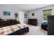 Comfortable carpeted bedroom featuring a large bed, ample furniture, and natural light from the window at 226 Calhoun Falls Dr., Myrtle Beach, SC 29579