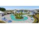 Stunning aerial view of the community pool with lazy river, cabanas, and a scenic setting at 226 Calhoun Falls Dr., Myrtle Beach, SC 29579