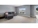 Cozy carpeted room with a gray sofa, natural light from the window, and a view of the outdoor scenery at 226 Calhoun Falls Dr., Myrtle Beach, SC 29579