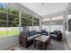 Cozy sunroom featuring wicker furniture, string lights, and views of the backyard at 226 Calhoun Falls Dr., Myrtle Beach, SC 29579