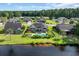 An aerial view features a home with a pool in a lush backyard, creating a relaxing waterfront retreat at 2369 Clandon Dr., Myrtle Beach, SC 29579