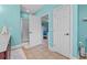 Bathroom showcasing a shower, tiled floors, and entry to a bedroom with bright blue bedding at 2369 Clandon Dr., Myrtle Beach, SC 29579