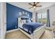 Bedroom with blue accent wall, a white bed with blue bedding, and a large window at 2369 Clandon Dr., Myrtle Beach, SC 29579