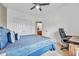 Bedroom with a blue bed, a desk with a rolling office chair, and ensuite bathroom access at 2369 Clandon Dr., Myrtle Beach, SC 29579