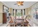 Elegant dining room featuring a ceiling fan, a wooden table with seating for six, and a bar for entertaining at 2369 Clandon Dr., Myrtle Beach, SC 29579
