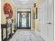 Bright foyer featuring a decorative front door, tile flooring, console table and stylish rug at 2369 Clandon Dr., Myrtle Beach, SC 29579