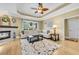 Bright living room featuring hardwood floors, tray ceiling, neutral decor, and a fireplace at 2369 Clandon Dr., Myrtle Beach, SC 29579