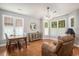 Cozy dining area with ample natural light, wooden table, and accent cabinet for storage at 2510 Oriole Dr., Murrells Inlet, SC 29576