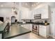 Well-equipped kitchen with white cabinetry, stainless steel appliances, and bar seating for casual meals at 2510 Oriole Dr., Murrells Inlet, SC 29576