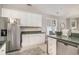 Efficient kitchen with white cabinets, stainless steel fridge, and access to the dining area at 2510 Oriole Dr., Murrells Inlet, SC 29576