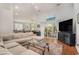 Spacious living room with a large sectional sofa, wood floors, and sliding glass doors to the patio at 2510 Oriole Dr., Murrells Inlet, SC 29576