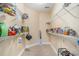 Walk-in pantry with ample shelving for organized storage, showcasing tile flooring and bright lighting at 2510 Oriole Dr., Murrells Inlet, SC 29576
