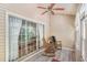 Cozy sunroom featuring sliding glass doors, rocking chairs, ceiling fan, and natural light at 2510 Oriole Dr., Murrells Inlet, SC 29576