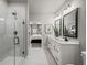 Bright bathroom featuring double sinks, a glass shower, and neutral tones at 2606 Elowen Ln. # 173A, Longs, SC 29568