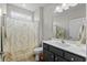 Clean bathroom with a shower-tub combination and a white patterned shower curtain, offering functionality and style at 264 Switchgrass Loop, Little River, SC 29566