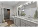 Elegant bathroom featuring double sinks, a vanity area, modern fixtures, and ample storage space at 264 Switchgrass Loop, Little River, SC 29566