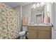 Well-lit bathroom with a decorative shower curtain and a spacious vanity, providing comfort and convenience at 264 Switchgrass Loop, Little River, SC 29566